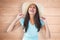 Composite image of happy young brunette wearing sunhat