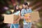 Composite image of happy young couple with moving boxes