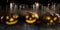 Composite image of high angle view of jack o lanterns with leaves on table