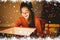 Composite image of little girl opening a glowing christmas gift