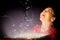 Composite image of little girl opening a magical christmas gift