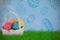 Composite image of mulit colored easter eggs in wicker basket