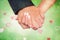 Composite image of newlyweds holding hands close up