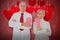 Composite image of older couple standing holding broken pink heart 3d