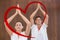 Composite image of peaceful couple in white doing yoga together with hands raised