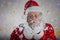 Composite image of playful santa claus blowing fake snow