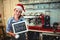 Composite image of portrait of barista holding christmas sign at cafe