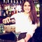 Composite image of portrait of bartender pouring blue martini drink in glass