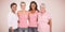 Composite image of portrait of happy women supporting breast cancer social issue