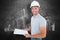 Composite image of portrait of manual worker holding clipboard