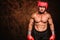 Composite image of portrait of shirtless man with boxing headgear and gloves