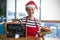 Composite image of portrait of waitress holding slate with merry x-mas sign and cake