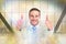 Composite image of positive businessman smiling with thumbs up