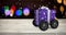 Composite image of purple wrapped with polka dot gift box on wheels