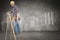 Composite image of repairman climbing ladder while holding power drill