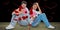 Composite image of sad couple sitting holding two halves of broken heart