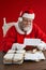 Composite image of santa claus reading wish lists