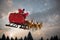 Composite image of santa claus riding on sleigh with gift box