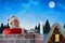 Composite image of santa claus using laptop on chimney
