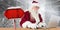 Composite image of santa surfs on the internet