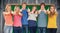 Composite image of six friends giving thumbs up as they smile