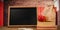 Composite image of slate with chalks by lunch bag and books on wooden table