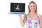 Composite image of smiling blonde holding laptop and posing