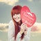 Composite image of smiling hipster woman with a big red heart