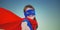 Composite image of smiling masked girl pretending to be superhero