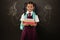 Composite image of smiling schoolgirl carrying books