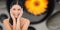Composite image of smiling sensual dark haired model touching her face
