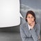 Composite image of smiling thoughtful businesswoman with speech bubble