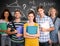 Composite image of students holding folders in college