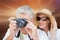 Composite image of vacationing couple taking photo