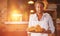 Composite image of waiter holding croissant on a tray