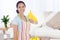 Composite image of woman in cleaning clothes giving thumbs up