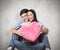 Composite image of young couple sitting on floor smiling