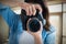 Composite image of young female photographing through camera