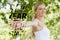 Composite image of young fit woman doing yoga in a park spreading her arms