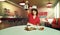 Composite image with young woman, waitress in 70s retro fashion uniform sitting at table with coffee on 3D model of