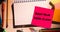 Composite of keep your desk clean text on sticky note and high angle view of office supplies