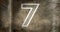 Composite of number 7 against rusty metallic background, copy space