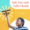 Composite of safe toys and gifts month text over african american boy with plane