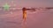 Composite video of chinese flag against rear view of african american woman walking on the beach