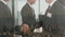 Composite video of two diverse businessmen shaking hands against aerial view of cityscape