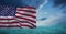 Composition of american flag billowing over blue ocean cloudy blue sky