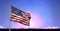 Composition of american flag billowing over blue and pink sunset sky