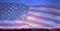 Composition of american flag billowing over grassy horizon and blue sky