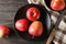 Composition with apples, plate and kitchen towel on wooden background