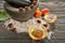 Composition with apricot essential oil, mortar and salt on wooden table